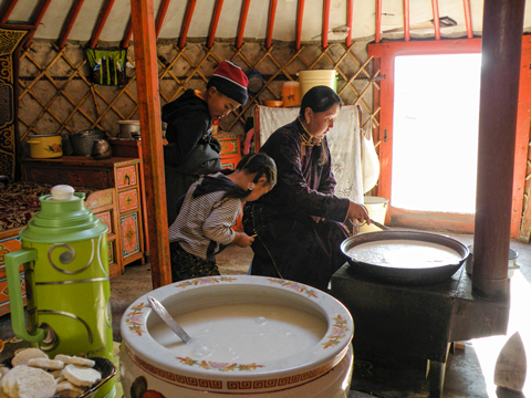 Mother preparing dinner in the Mongolian steppe