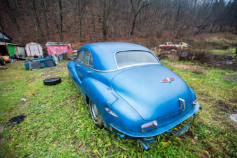 Old blue car in yard Versailles Kentucky