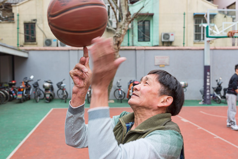 man spinning a basketball in shanghai china