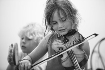 young girl playing fiddle in Newfoundland
